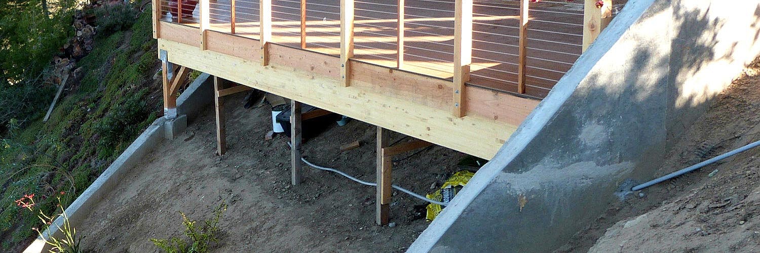 Mini excavator working in a parking garage.