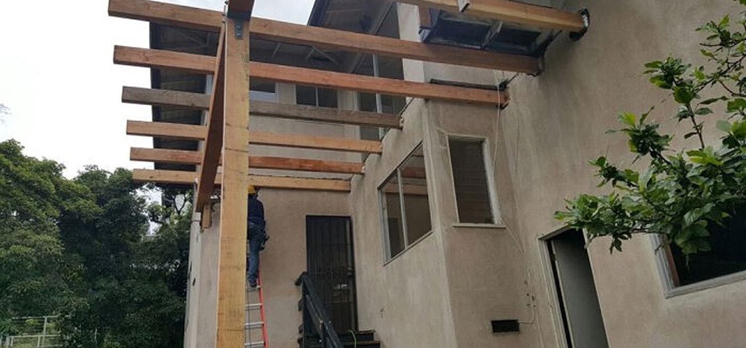 Construction of wooden awning over entrance.