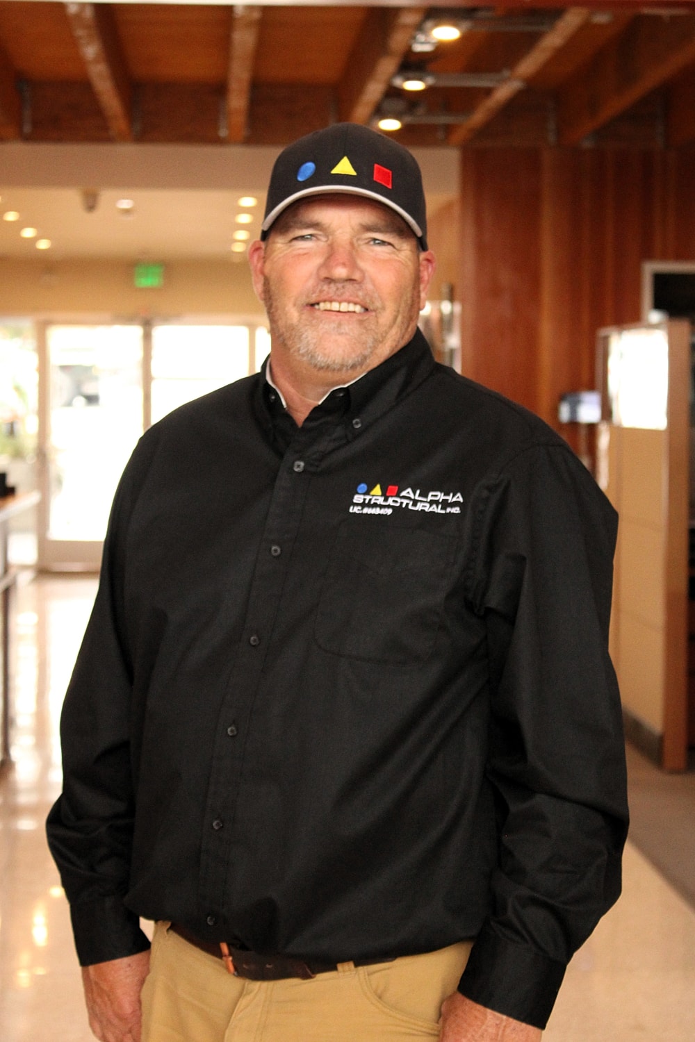 Man in work uniform smiling for the camera