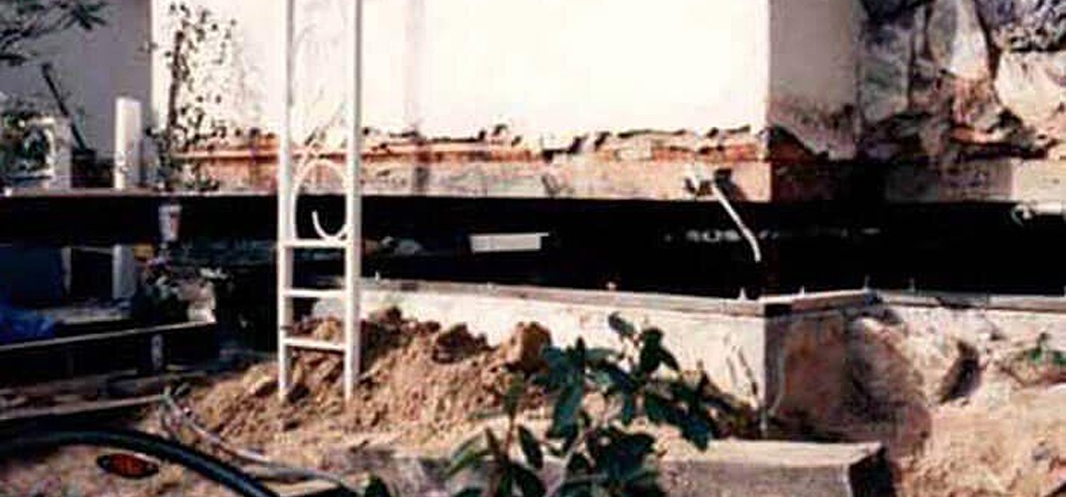 Construction site with plastic covering wooden framing.