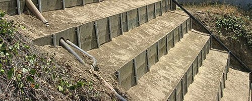 Stepped retaining wall with soil layers.