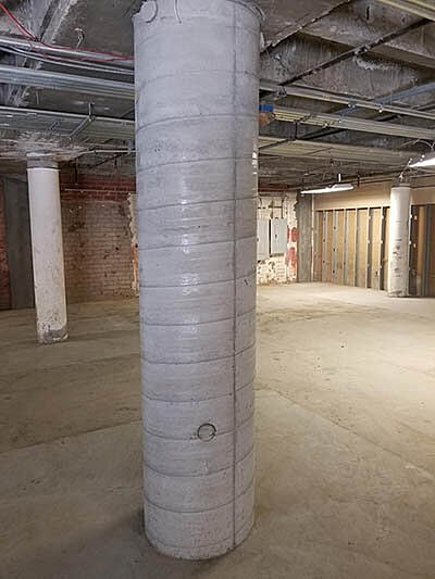 Smiling man in a black polo shirt.