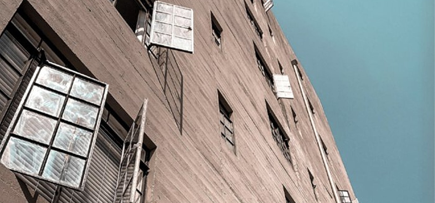 Building exterior with windows and blue sky.