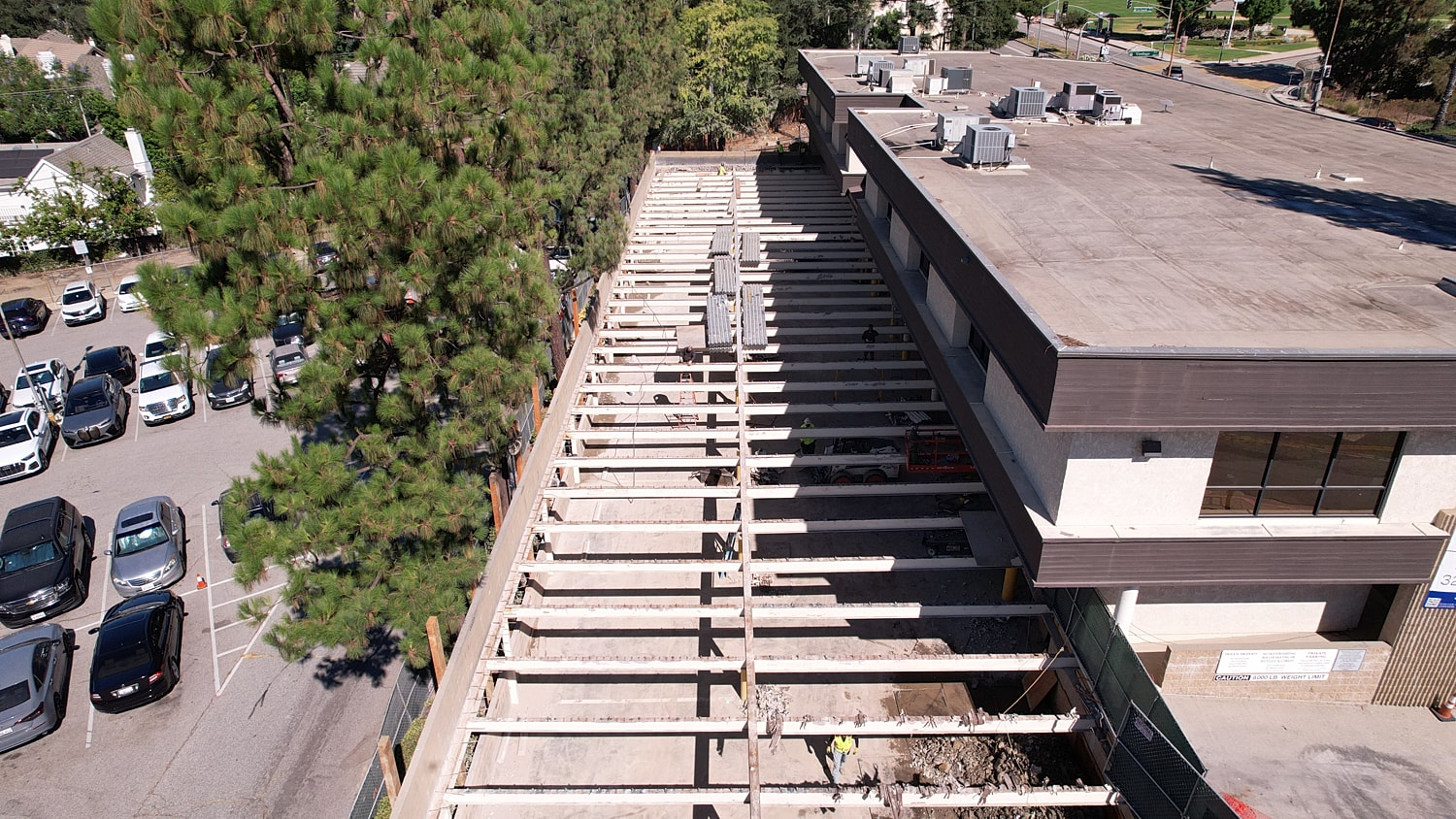 Construction site with wooden beams and vehicles.