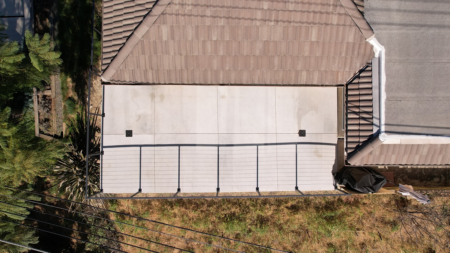 Aerial view of residential patio and roof.