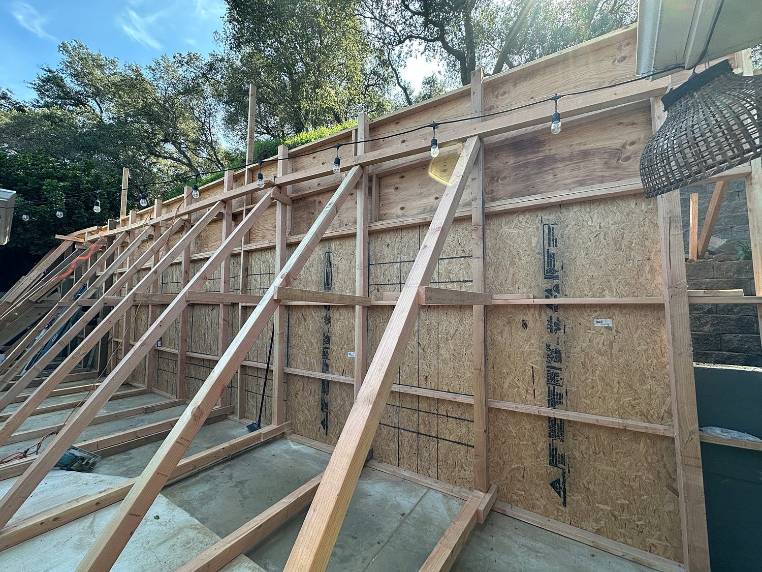 Construction site with wooden framework and lighting.