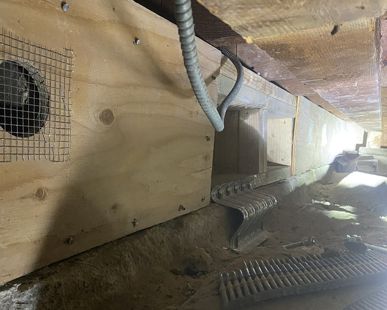 Cracked foundation with metal bracket support.