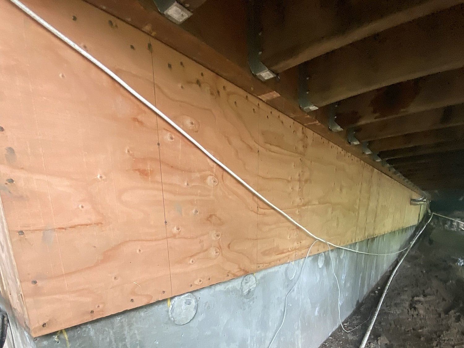 Plywood wall installation in a basement space.