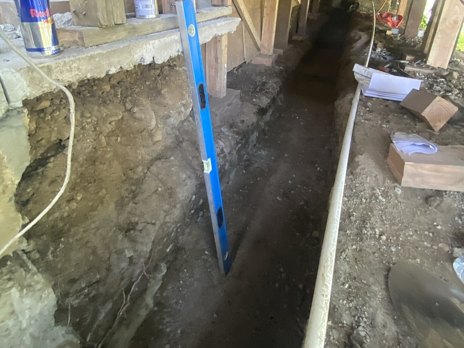Trenches and construction tools in a worksite.