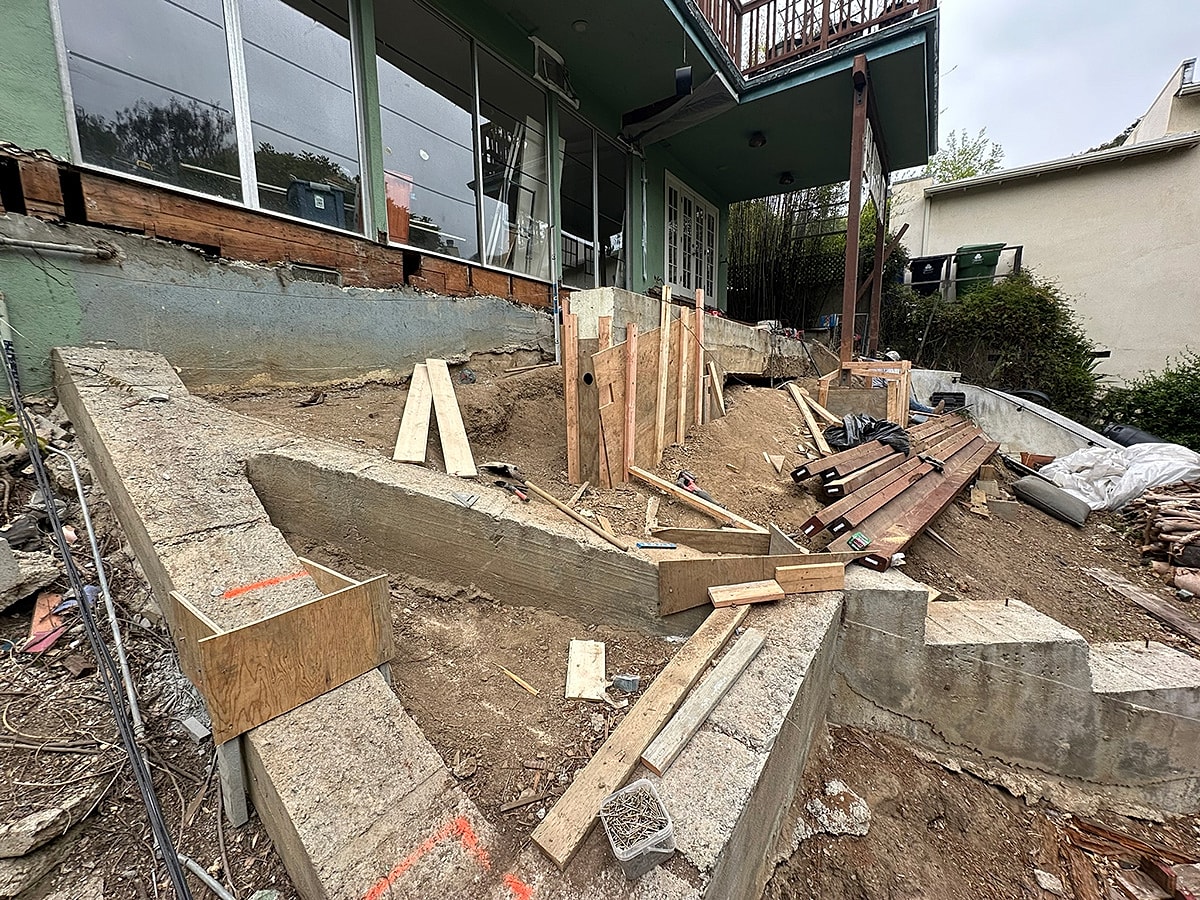 Construction site with materials and unfinished landscaping.