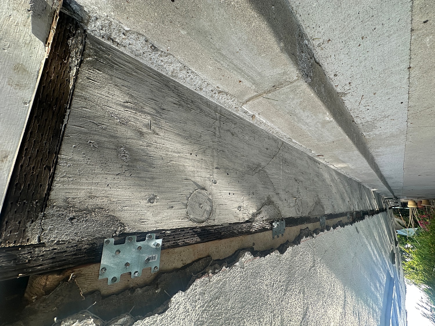 Concrete foundation and wooden beams detail.