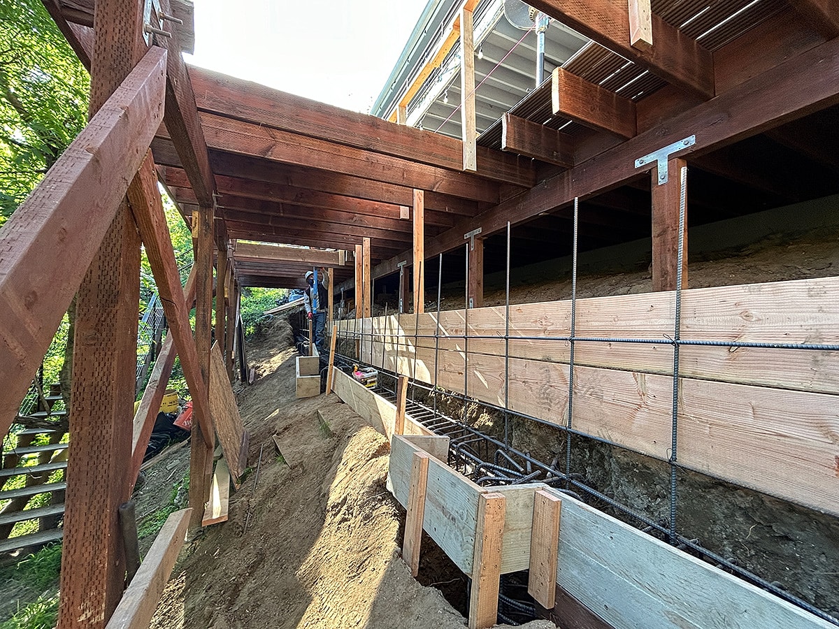 Construction site with wooden supports and rebar.