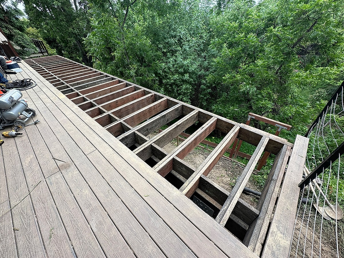 Deck under construction with wooden beams visible.