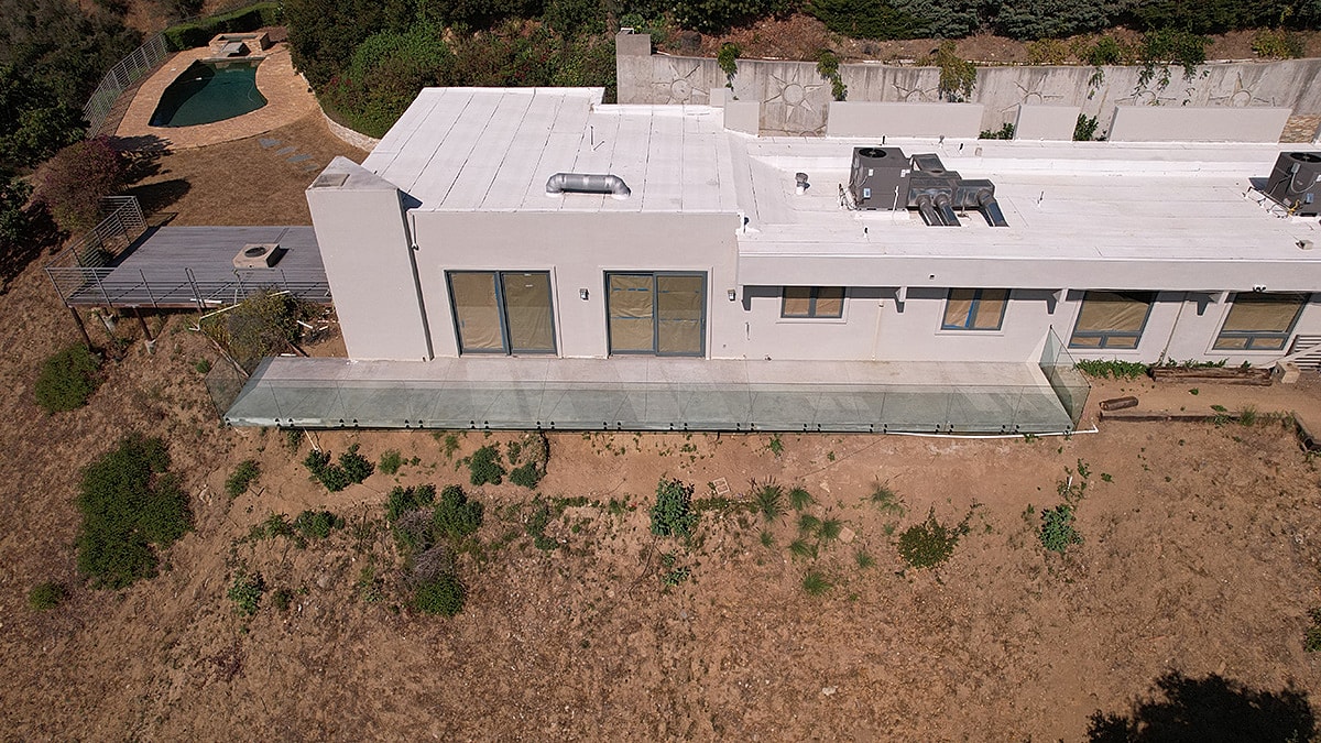 Aerial view of modern home and pool.