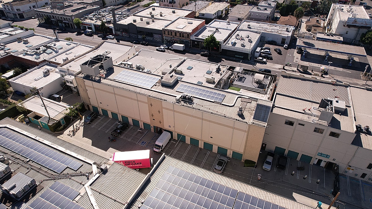 Aerial view of urban buildings with solar panels.