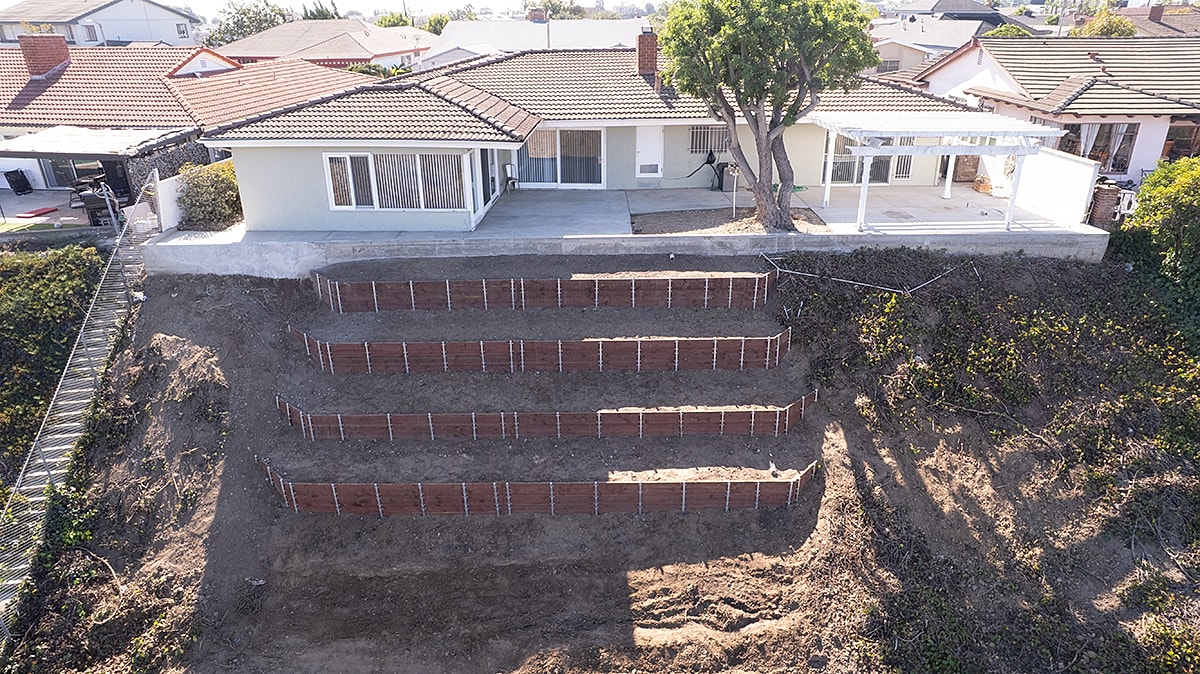 House with terraced landscaping on a hillside.