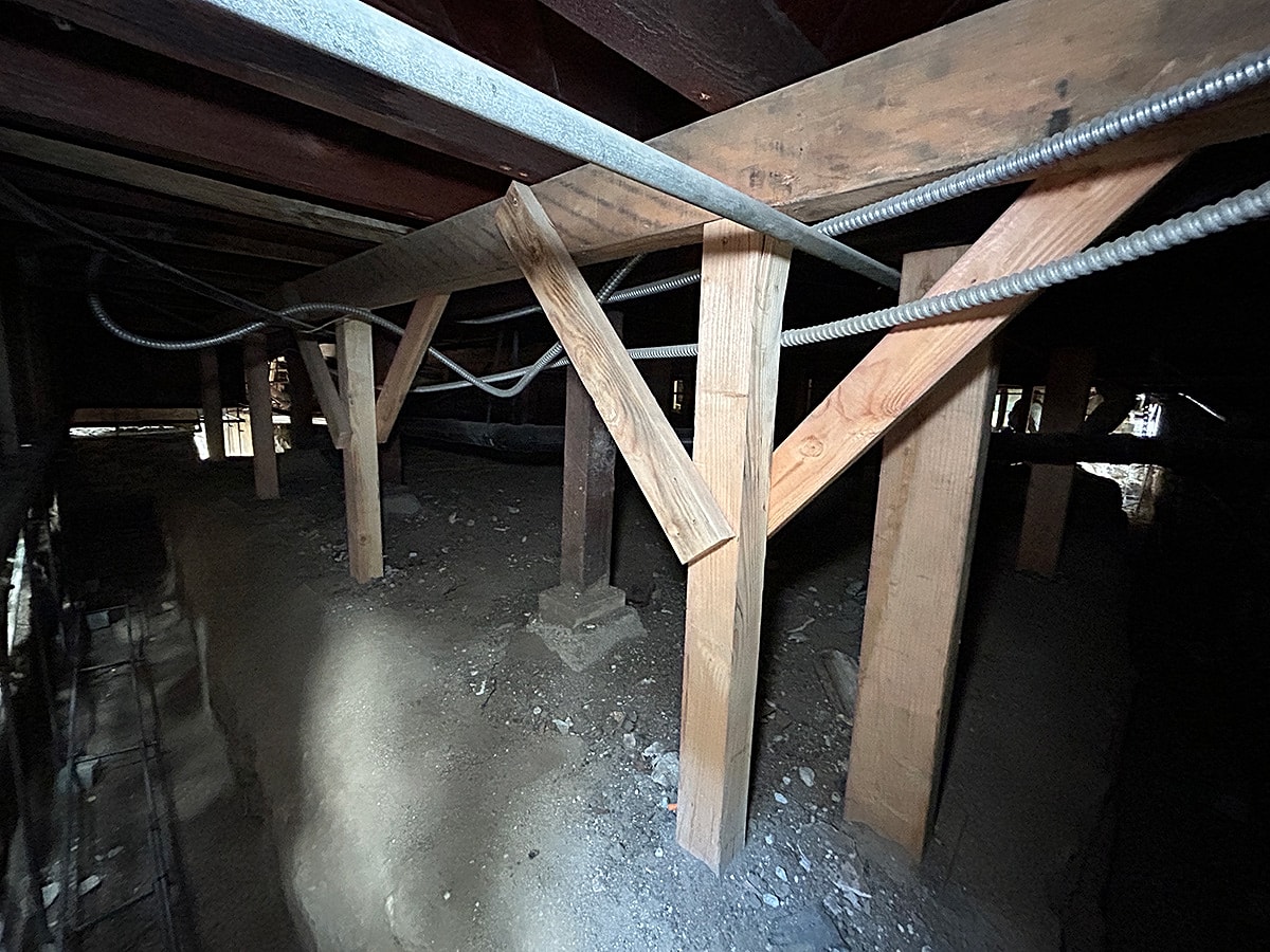Underneath wooden structure with support beams.