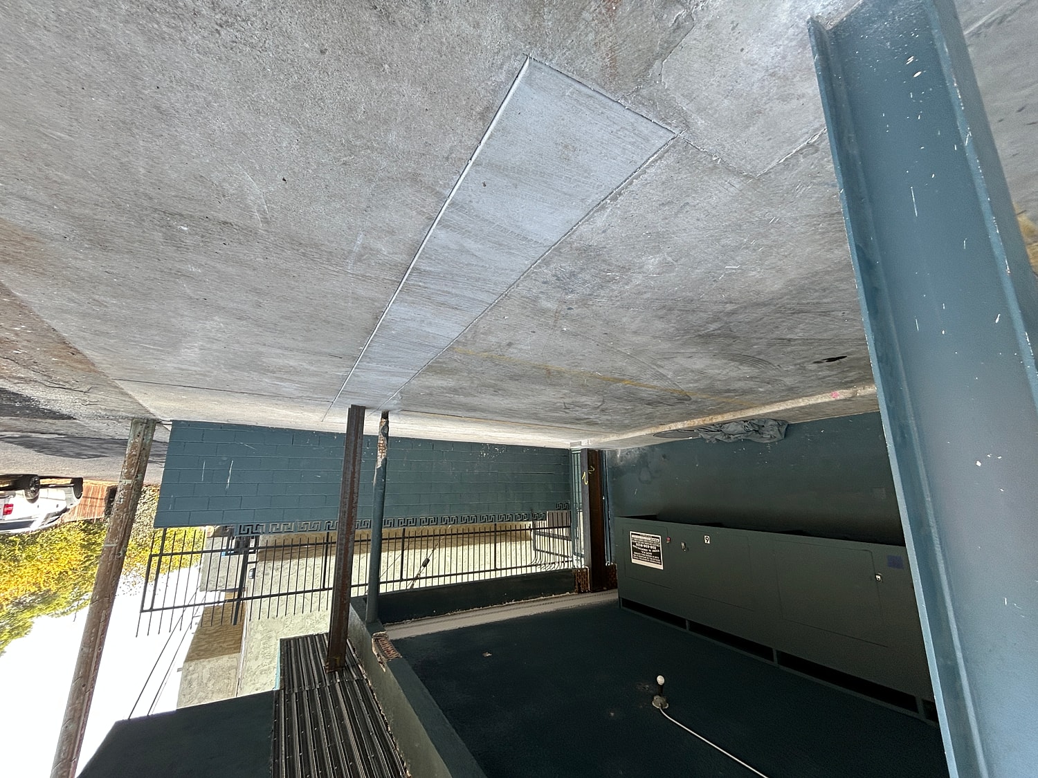 Underground parking area with concrete walls and floor.
