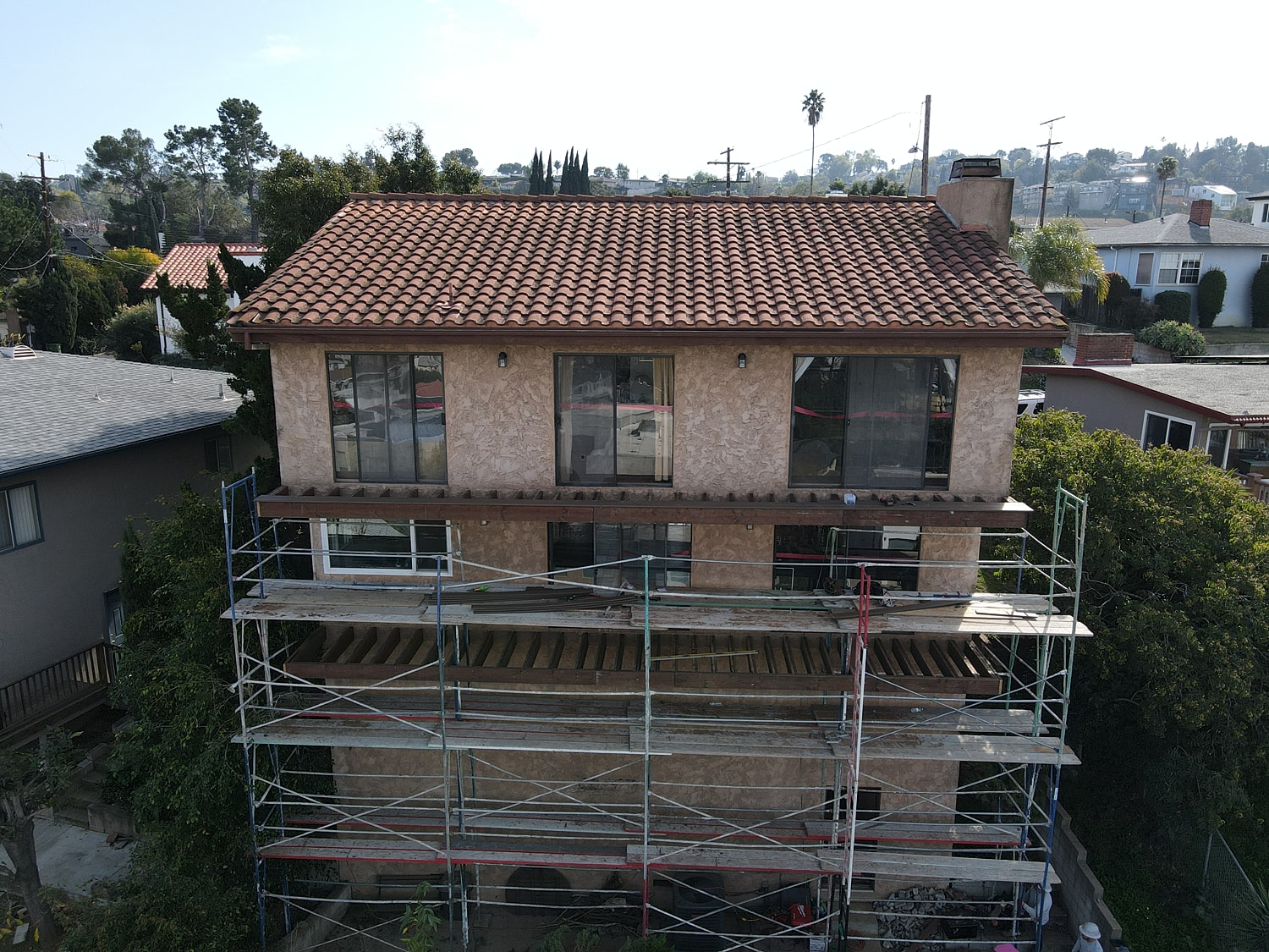 House undergoing renovation with scaffolding visible.