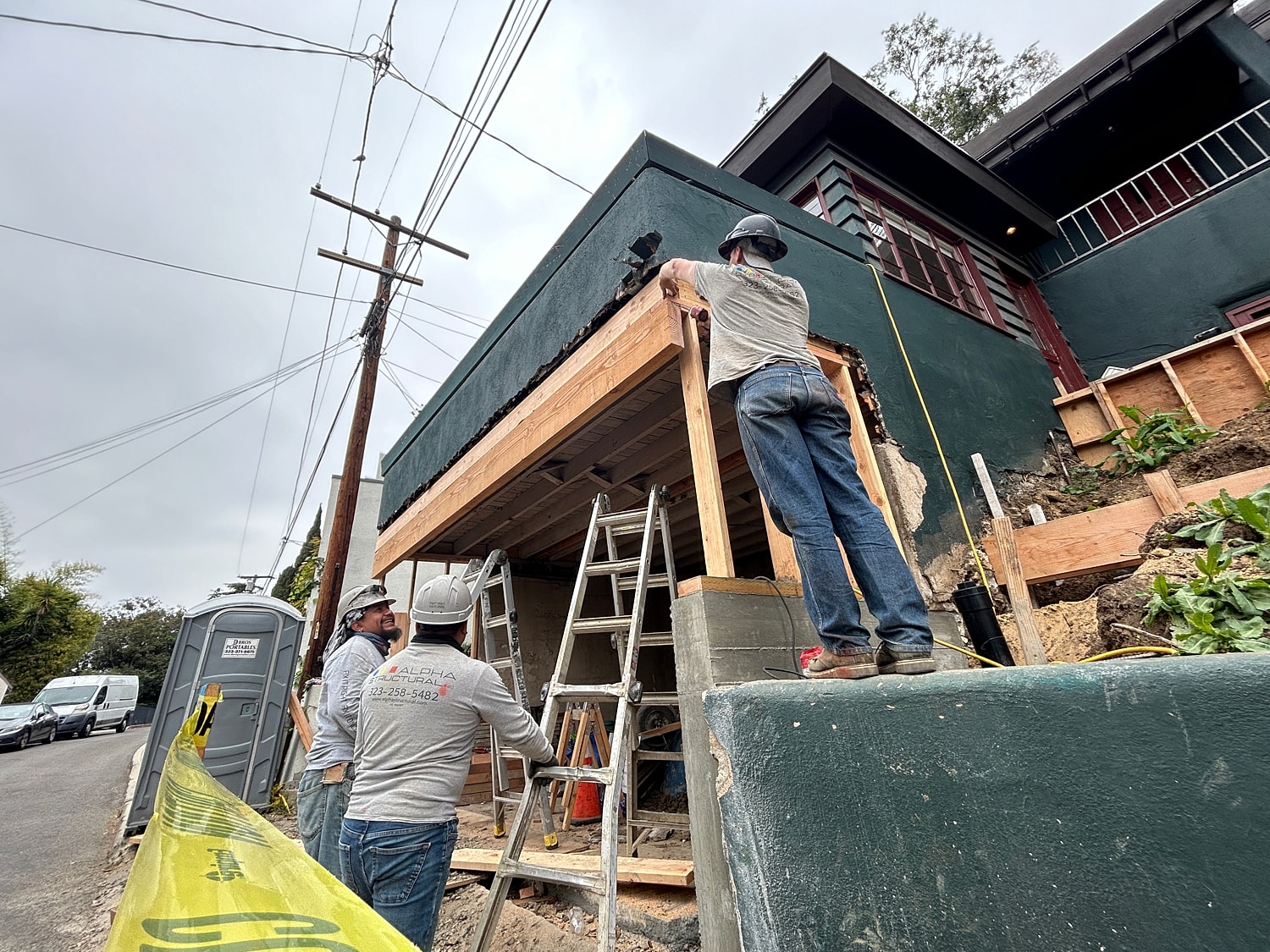 Construction workers renovating a house exterior.