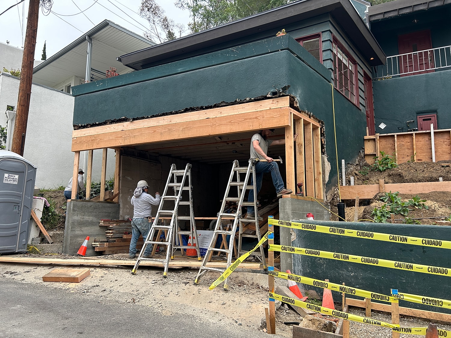 Construction workers renovating building exterior.