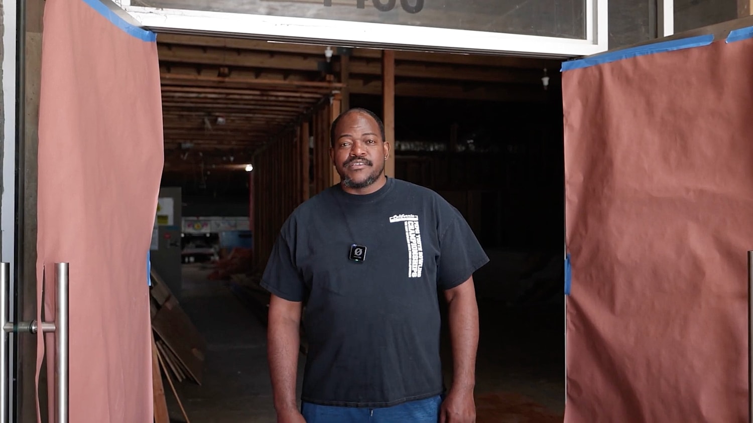 Man standing at entrance of a construction site.
