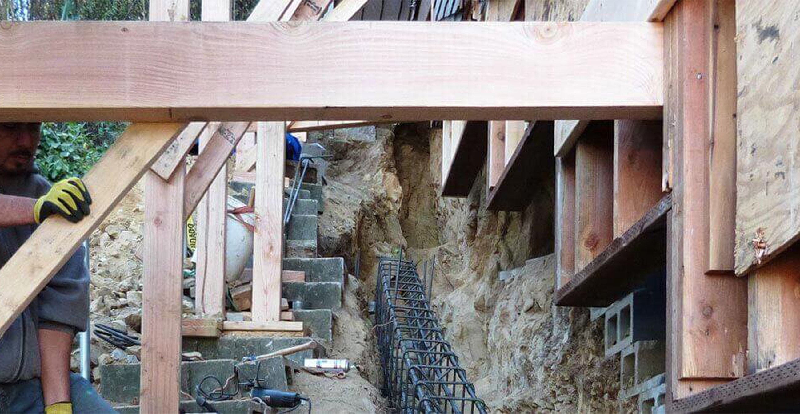 Construction site with wooden framing and tools.