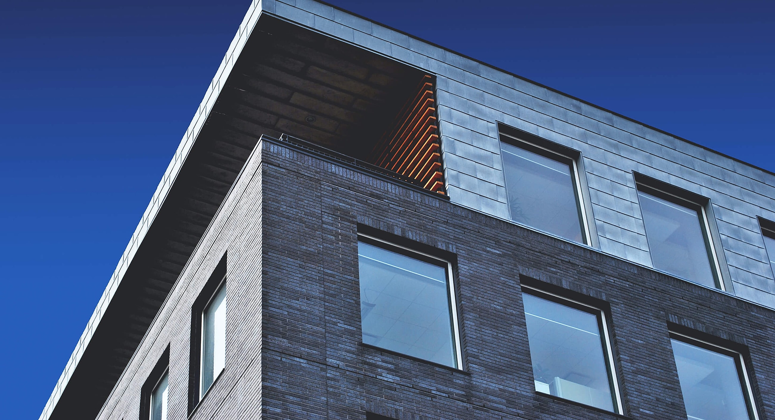 Modern building with angular design against blue sky.