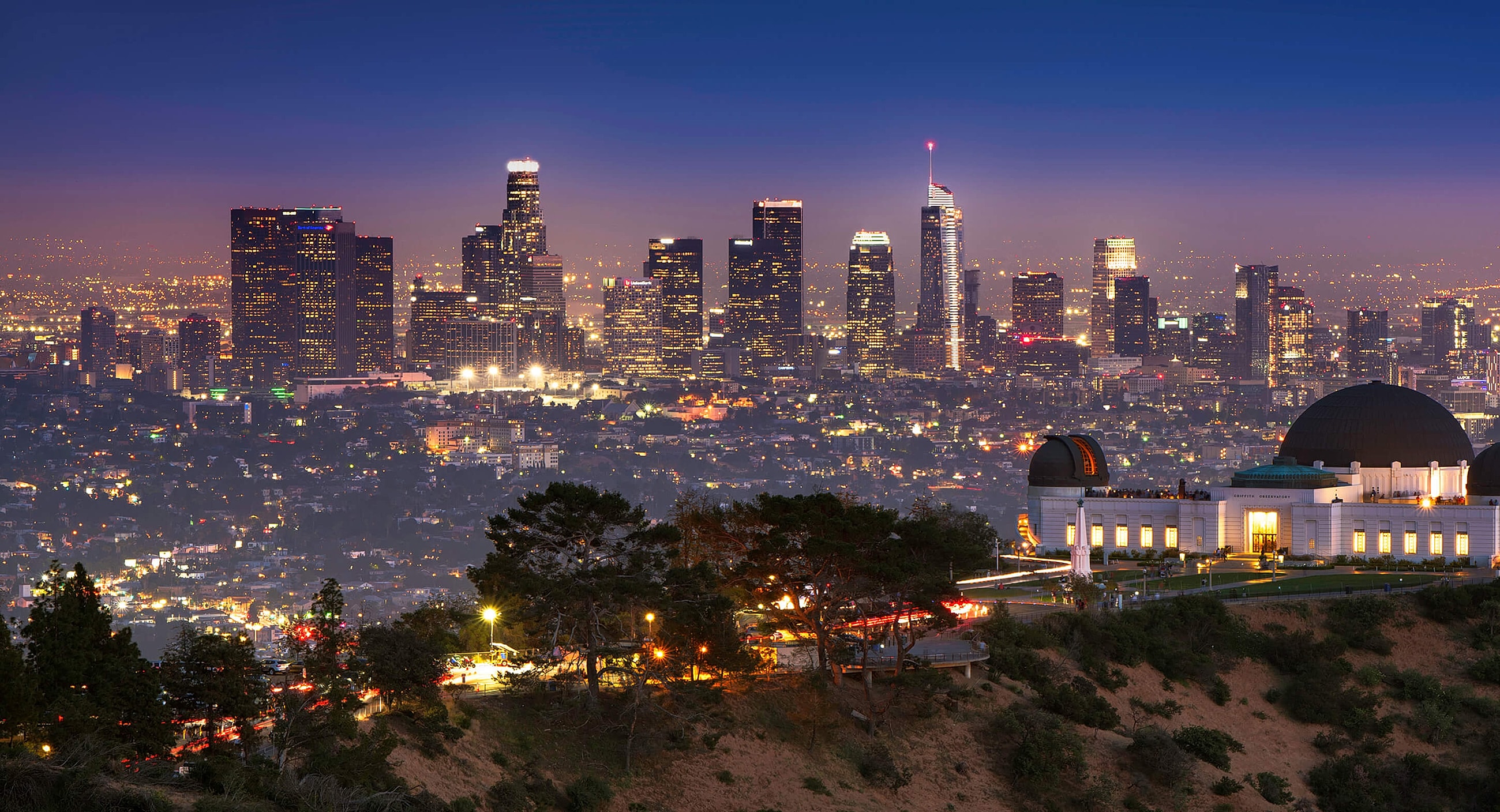 Los Angeles skyline at dusk with observatory.