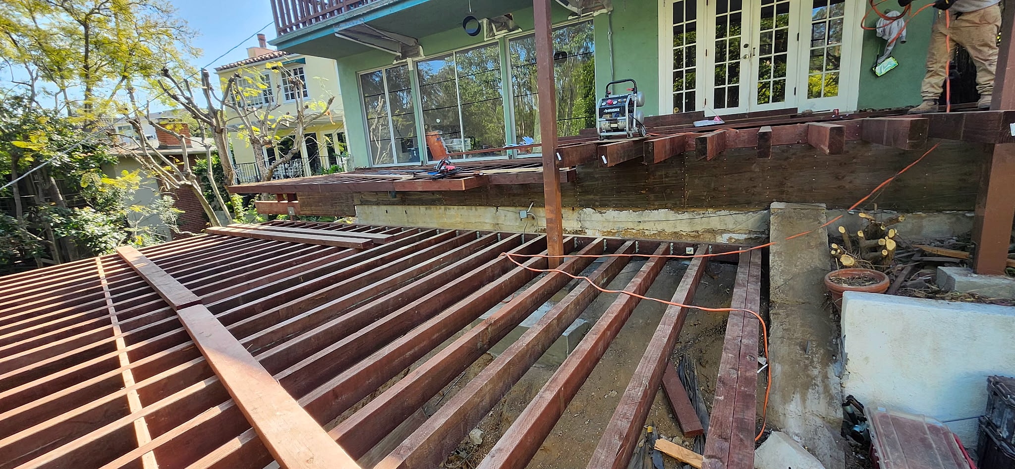 Under-construction deck with wooden support beams.